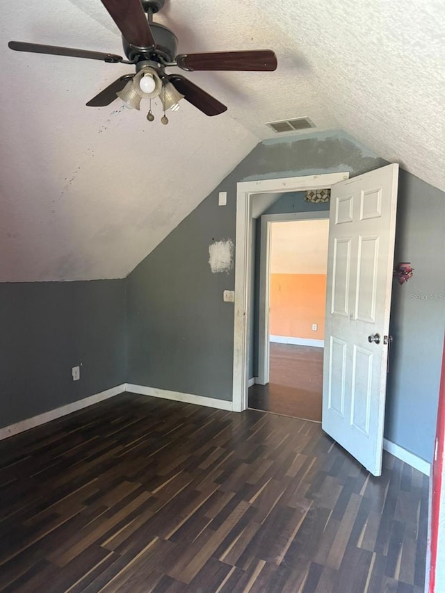 1700 Kentucky Ave, Saint Cloud, FL 34769 - bonus room featuring lofted ceiling, ceiling fan, dark hardwood / wood-style floors, and a textured ceiling