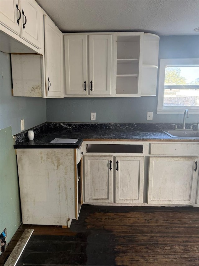 1700 Kentucky Ave, Saint Cloud, FL 34769 - kitchen featuring white cabinetry, sink, dark hardwood / wood-style flooring, and a textured ceiling