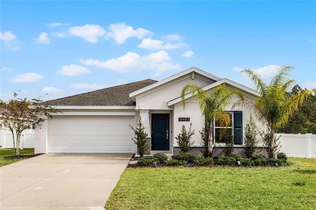 ranch-style home featuring a front lawn and a garage