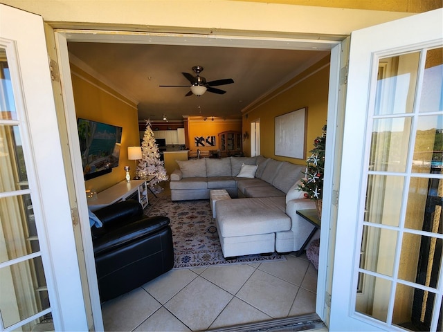 living room with ceiling fan, ornamental molding, and light tile patterned flooring