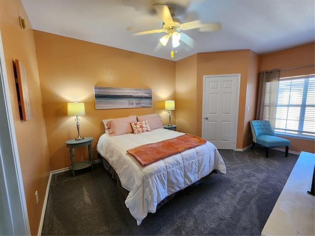 carpeted bedroom with baseboards and a ceiling fan