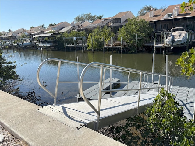 dock area with a residential view and a water view