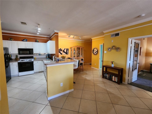 kitchen featuring light tile patterned floors, visible vents, a peninsula, and black appliances