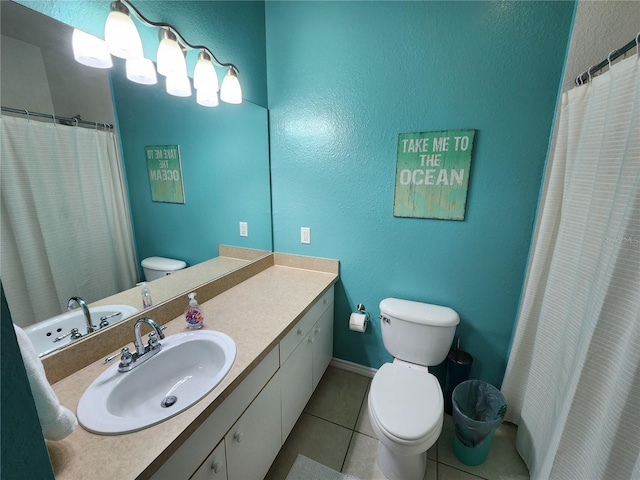 full bath featuring baseboards, toilet, vanity, and tile patterned flooring