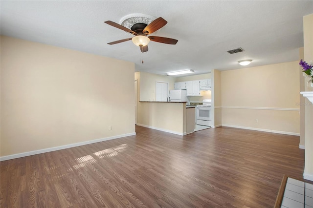 unfurnished living room featuring ceiling fan and dark wood-type flooring