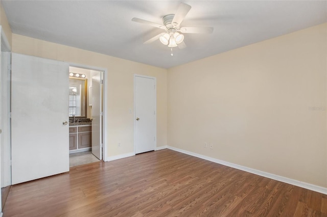 unfurnished room featuring hardwood / wood-style floors and ceiling fan