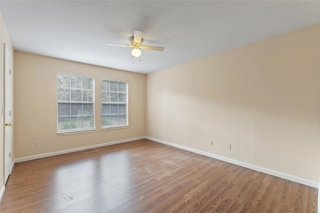 empty room with ceiling fan and wood-type flooring