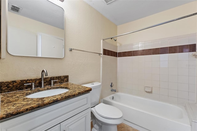 full bathroom featuring toilet, vanity, and tiled shower / bath combo