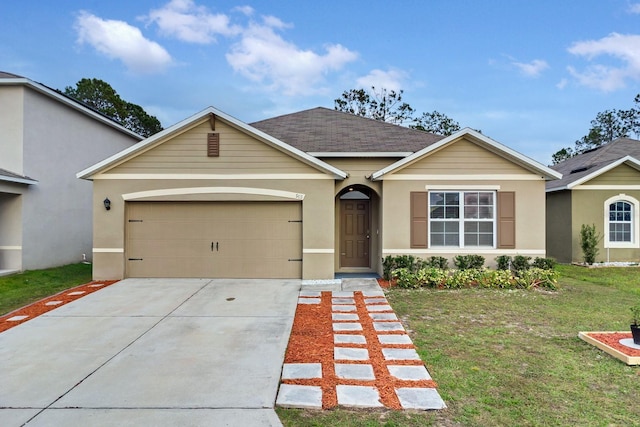 view of front of property with a garage and a front lawn