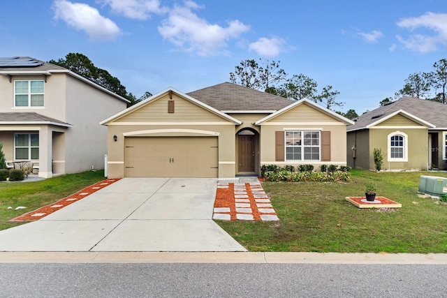 view of front of property featuring a garage and a front yard