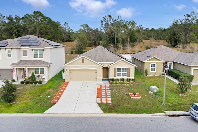 view of front of home with a garage, solar panels, and a front lawn