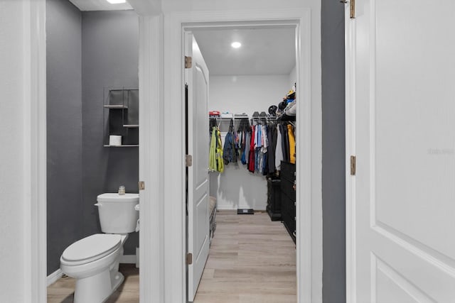 bathroom with toilet and hardwood / wood-style floors