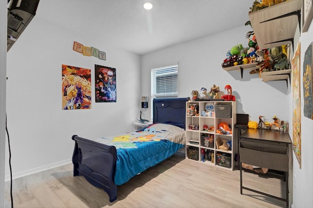 bedroom with hardwood / wood-style floors