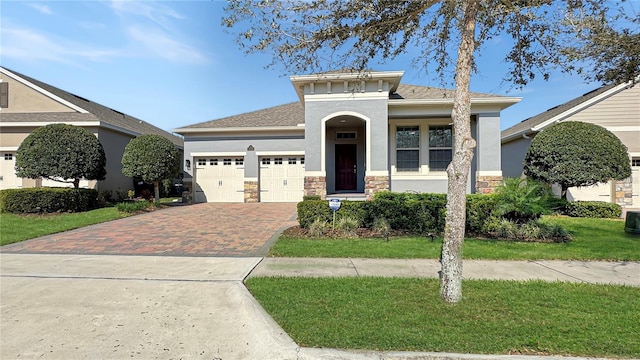 view of front of property featuring a garage and a front lawn