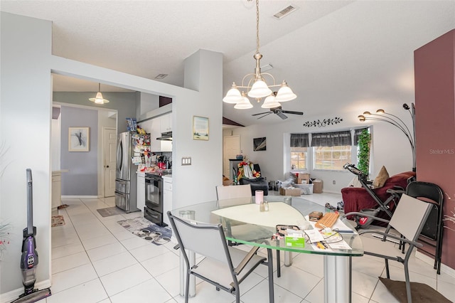 dining space featuring a textured ceiling, ceiling fan, light tile patterned floors, and vaulted ceiling