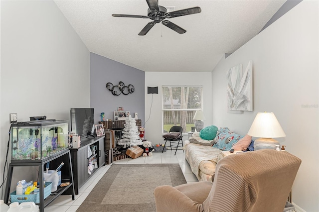 tiled living room with ceiling fan and a textured ceiling