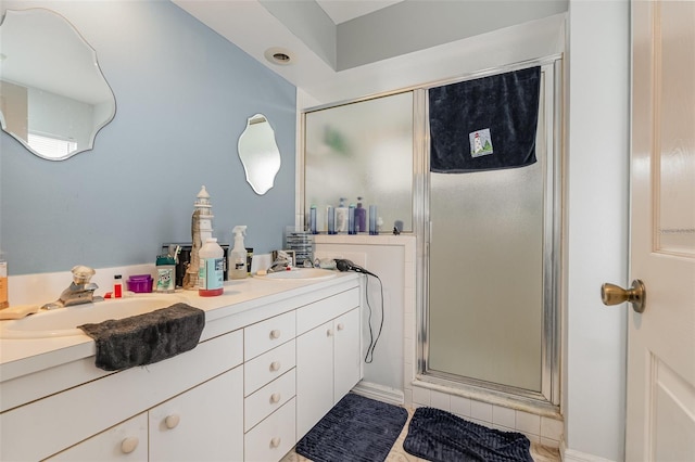 bathroom with vanity and a shower with shower door