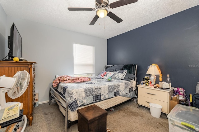 carpeted bedroom featuring a textured ceiling and ceiling fan