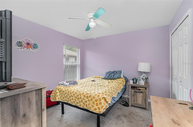 carpeted bedroom featuring a closet and ceiling fan