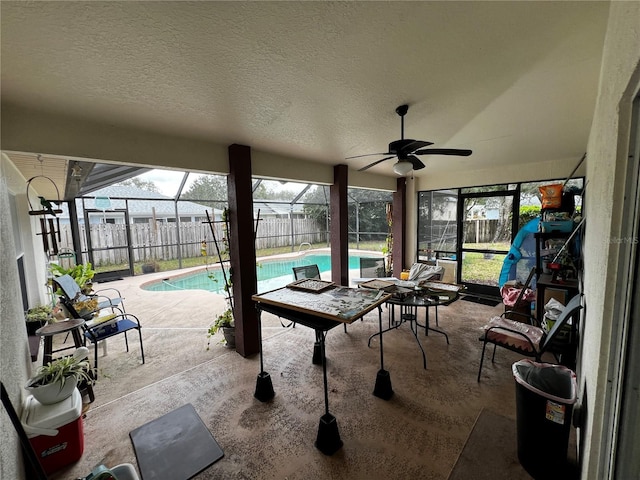 view of patio with a fenced in pool, ceiling fan, and a lanai