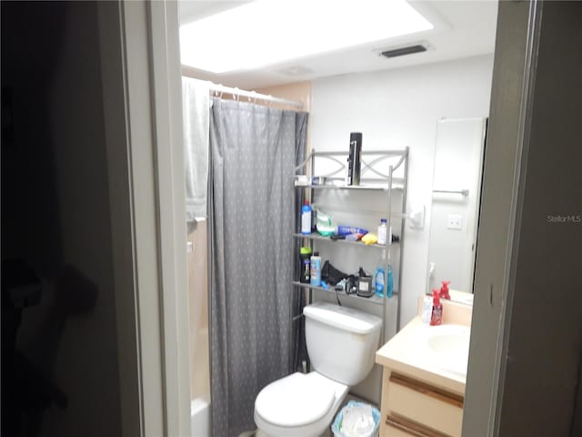 full bathroom with vanity, shower / bath combination with curtain, and toilet