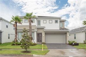 view of front of property featuring a garage and a front lawn