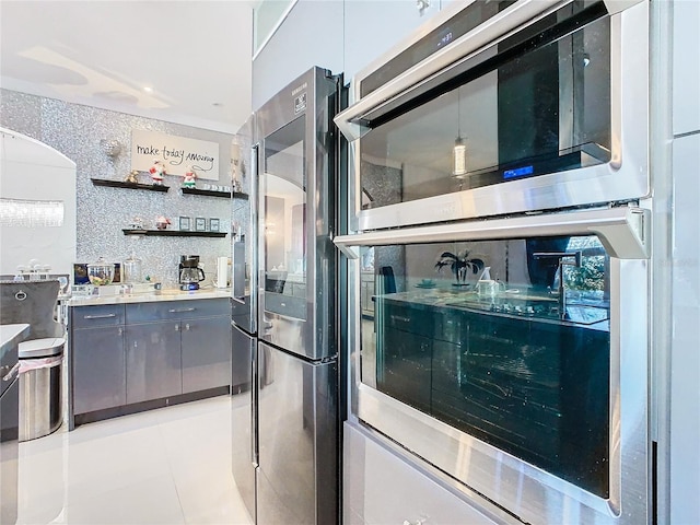 kitchen with light tile patterned floors and stainless steel appliances