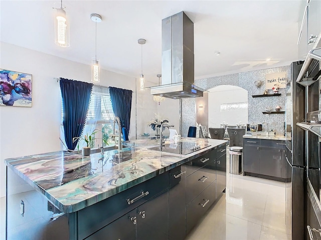 kitchen featuring pendant lighting, black electric stovetop, light tile patterned floors, tile walls, and island exhaust hood