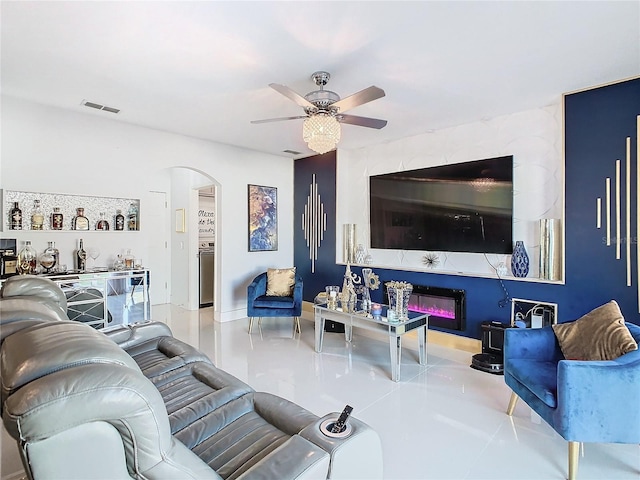 tiled living room with ceiling fan