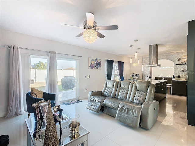 living room with ceiling fan, plenty of natural light, and light tile patterned floors