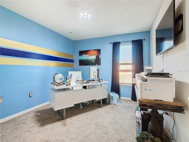 carpeted office space with a textured ceiling