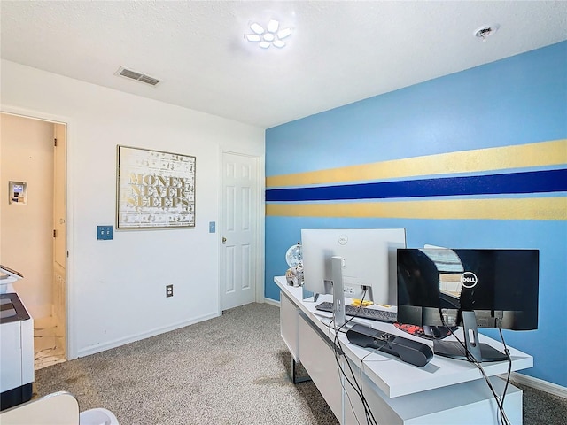 carpeted home office with a textured ceiling