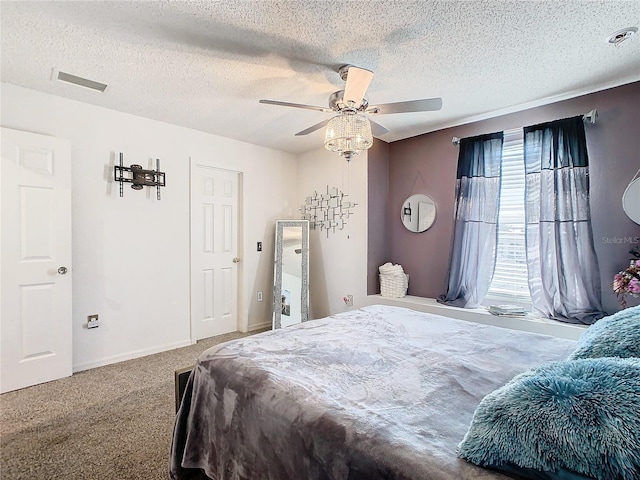 bedroom with carpet flooring, ceiling fan, and a textured ceiling