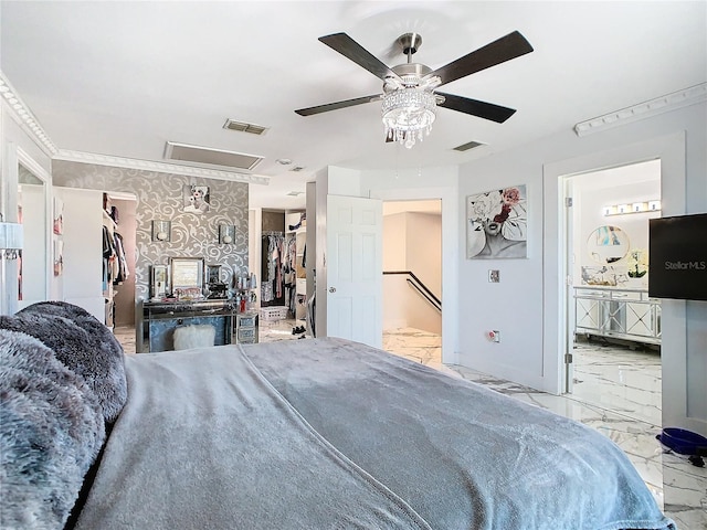 bedroom with ceiling fan, a closet, a walk in closet, and ensuite bath