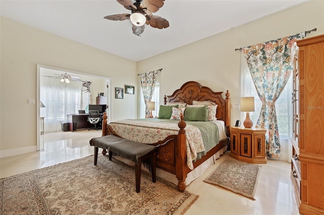 bedroom with ceiling fan and baseboards