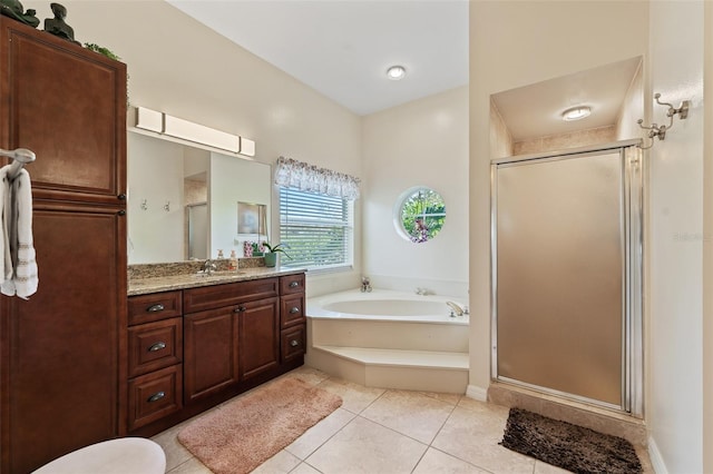 full bath featuring a garden tub, a shower stall, vanity, and tile patterned floors