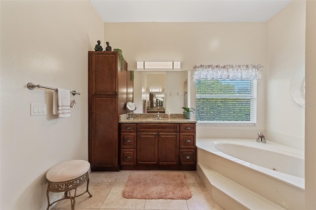 bathroom with vanity, a bath, and tile patterned floors