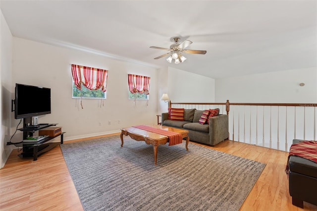 living room featuring light wood-style floors, ceiling fan, and baseboards