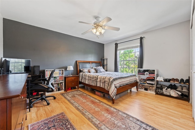 bedroom with a ceiling fan and wood finished floors