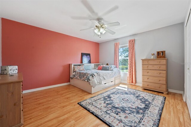 bedroom featuring ceiling fan, wood finished floors, and baseboards