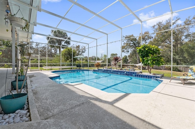 view of swimming pool with glass enclosure, a fenced in pool, and a patio