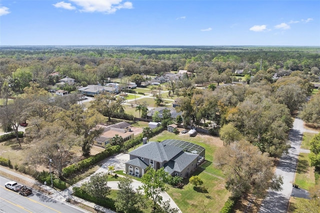 drone / aerial view with a wooded view