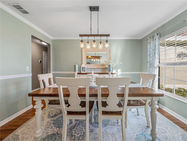 dining area with plenty of natural light, wood-type flooring, and ornamental molding