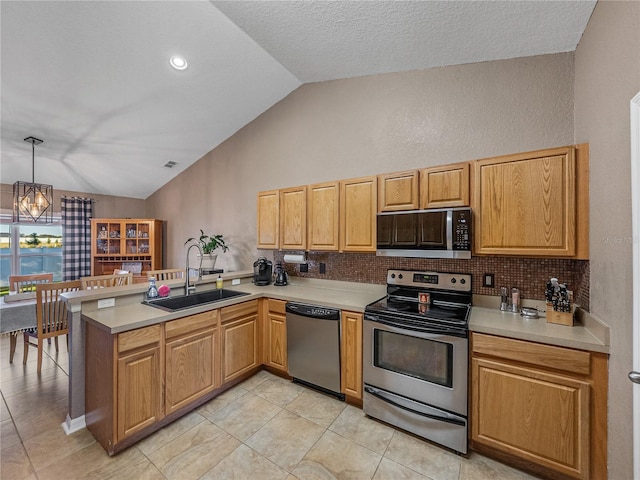 kitchen featuring sink, decorative light fixtures, appliances with stainless steel finishes, a notable chandelier, and kitchen peninsula