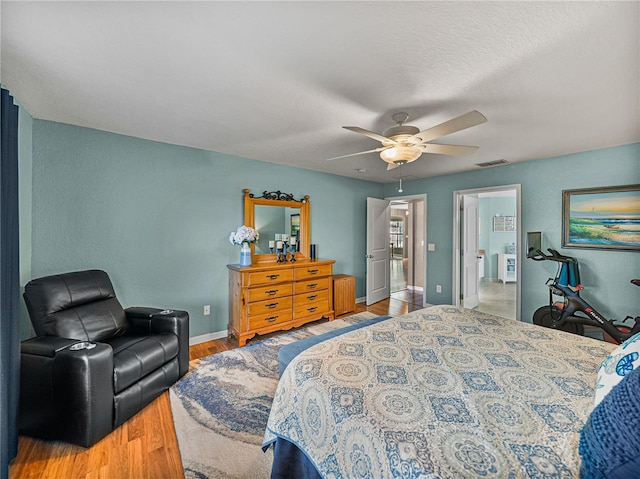 bedroom featuring light hardwood / wood-style flooring and ceiling fan