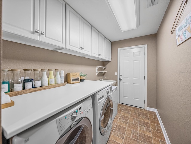 laundry area with cabinets and independent washer and dryer