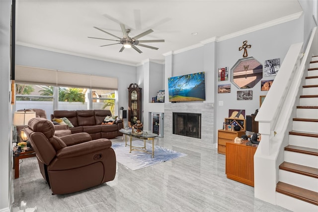 living room featuring a fireplace, ceiling fan, and ornamental molding