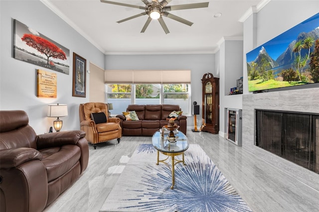 living room featuring a fireplace, ceiling fan, and crown molding