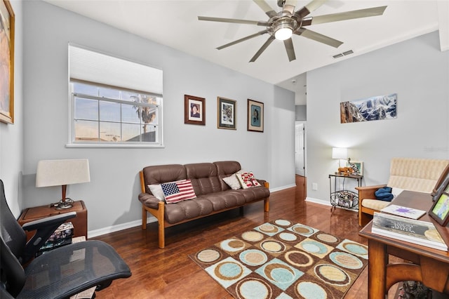 living room with ceiling fan and dark wood-type flooring