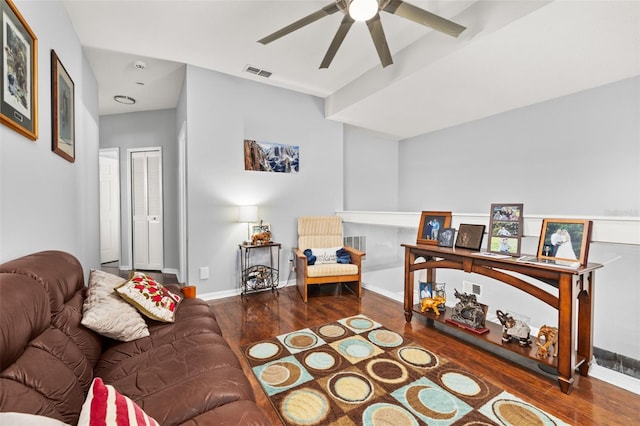 living room with ceiling fan and dark hardwood / wood-style flooring